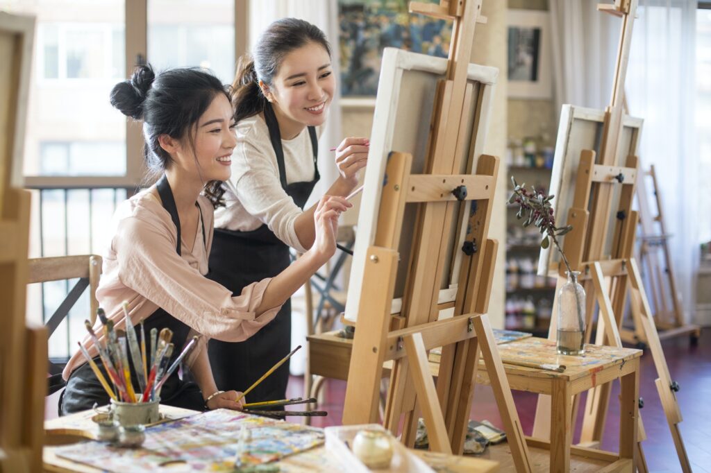 Young women painting in studio
